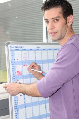 Man writing on a white board planner clipart