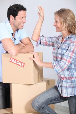 Couple with boxes smiling clipart