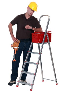 Tradesman looking at his watch clipart