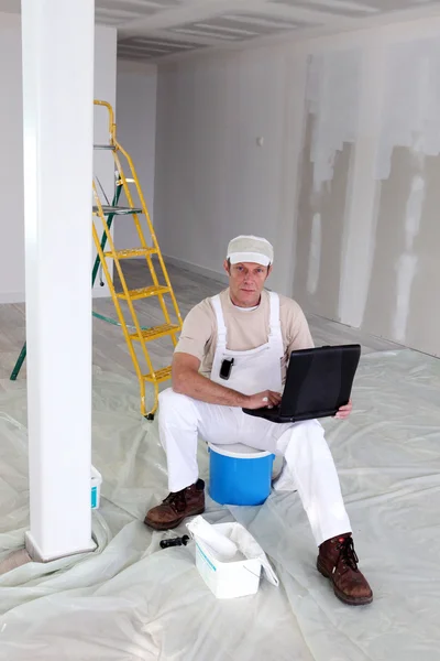 Pintor sentou-se na escada com laptop — Fotografia de Stock