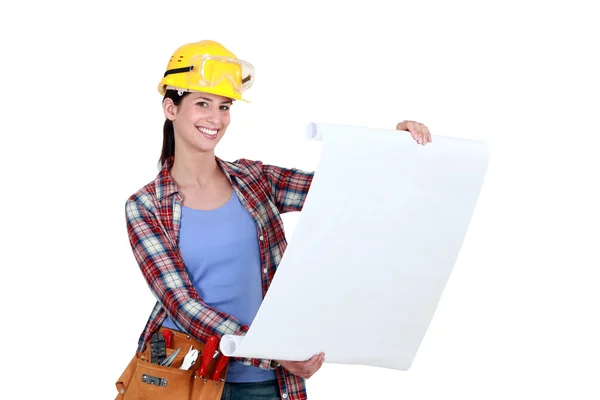 Tradeswoman examining a blueprint — Stock Photo, Image