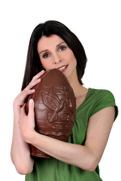 Woman with an enormous chocolate egg — Stock Photo, Image