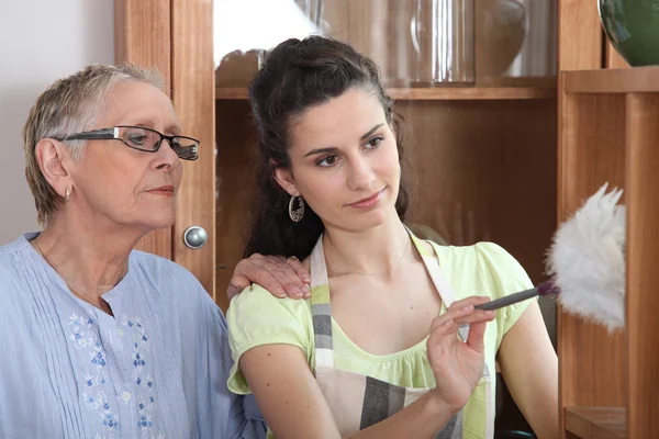 stock image Young woman helping senior lady with the cleaning