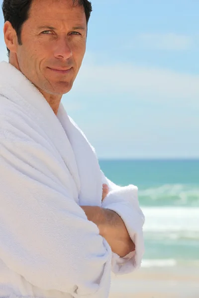 Man on the beach in bath robes — Stock Photo, Image