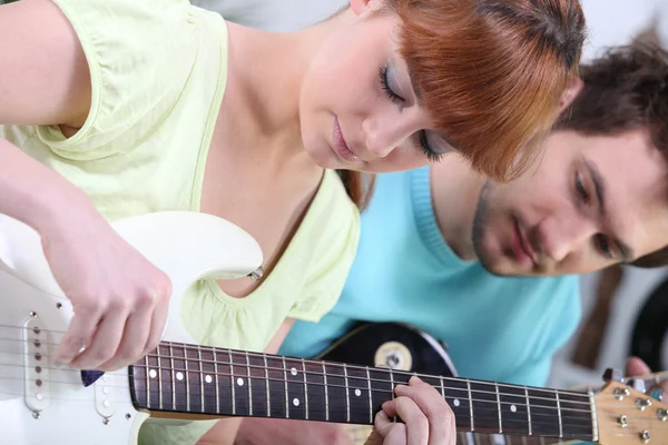 Teenagers with guitar indoors — Stock Photo, Image