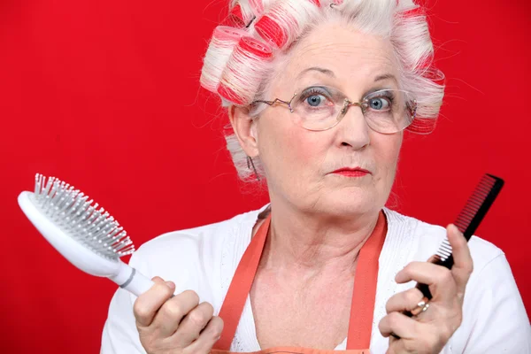 Senior woman with hair curlers — Stock Photo, Image