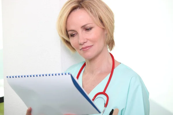 Nurse looking at chart — Stock Photo, Image