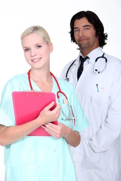 Jovem médico e enfermeira posando juntos — Fotografia de Stock