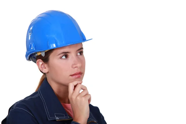 A thoughtful female construction worker. Stock Picture