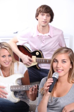 Teenagers playing music instruments clipart