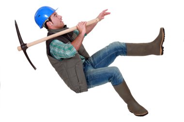 Man with pick-axe falling off chair clipart