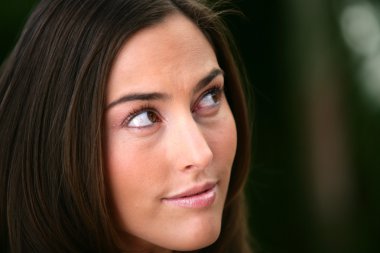 Portrait of a woman looking out of the corner of her eye clipart