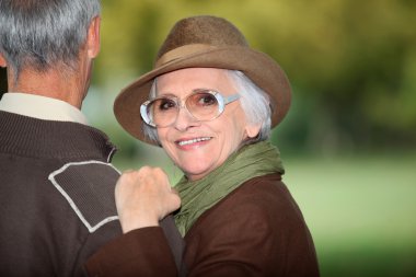 Woman with her arm on her husband's shoulder clipart