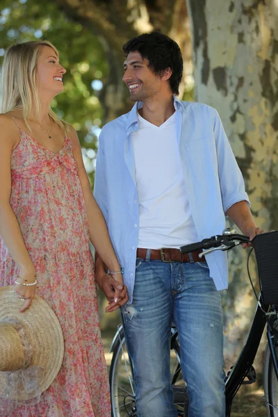 Romantic couple with a bike — Stock Photo, Image