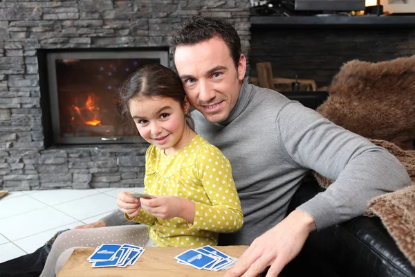 Young girl playing a game with her father — Stock Photo, Image