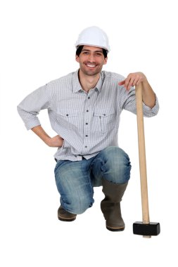 A construction worker with a sledgehammer. clipart