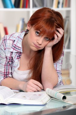 Bored student hitting the books clipart