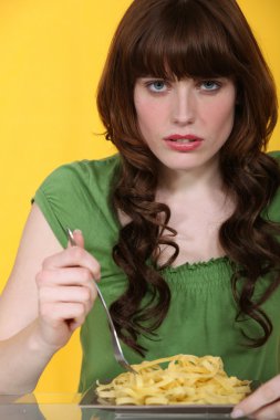 Woman eating plain tagliatelle clipart