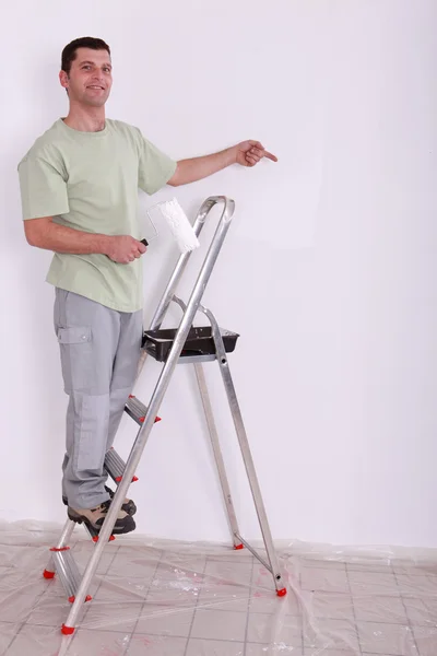 Decorator pointing at copyspace — Stock Photo, Image