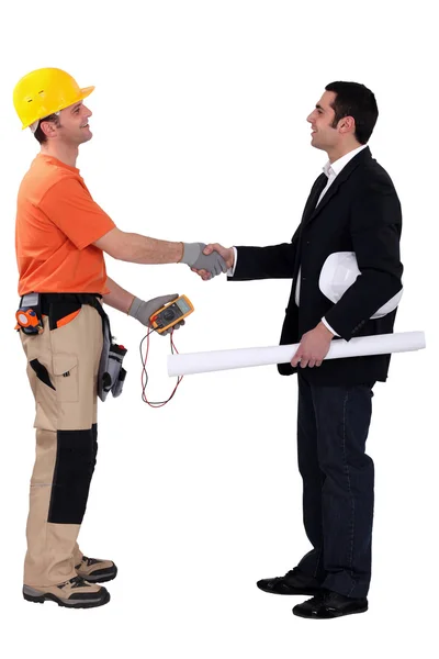 Architect and electrician shaking hands — Stockfoto
