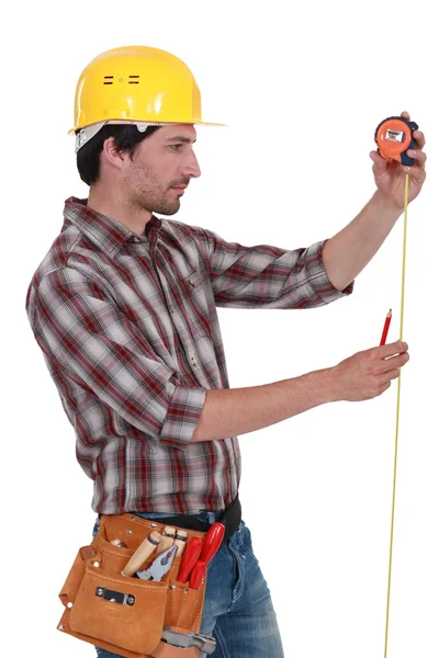 Man measuring using tape measure — Stok fotoğraf