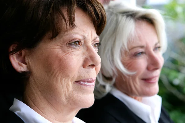 Two mature businesswomen posing together — Stok fotoğraf