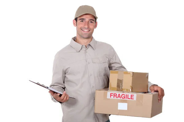 Male courier with parcels and a clipboard — Stock Photo, Image
