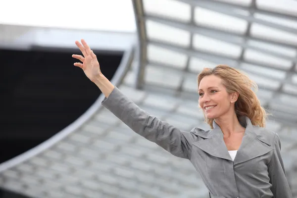 Businesswoman waving — Stock Photo, Image