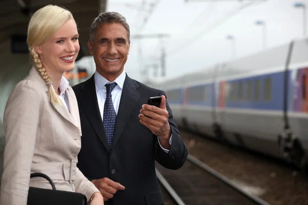 Portrait of handsome mature businessman and young female assistant — Stock Photo, Image