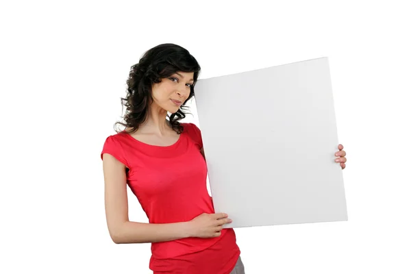 Woman holding a board left blank for your message — Stockfoto