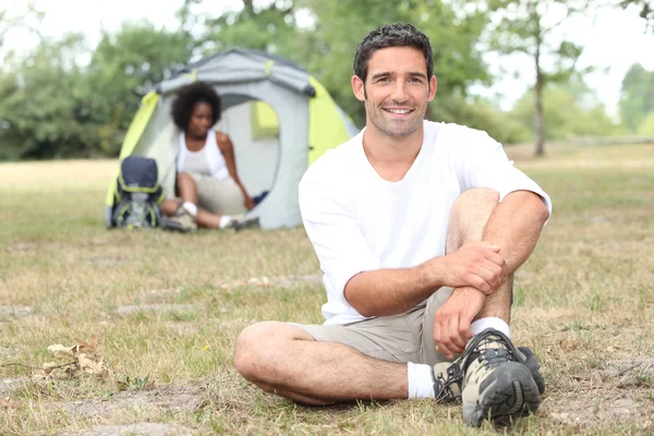 Mixed race couple camping in tent — Stock Photo, Image