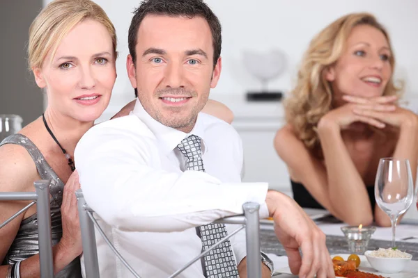 Couple at dinner party with friends — Stock Photo, Image