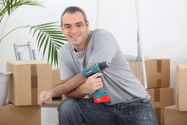 Man with an electric screwdriver — Stock Photo, Image
