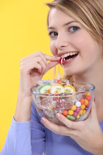 stock image Young woman eating sweets