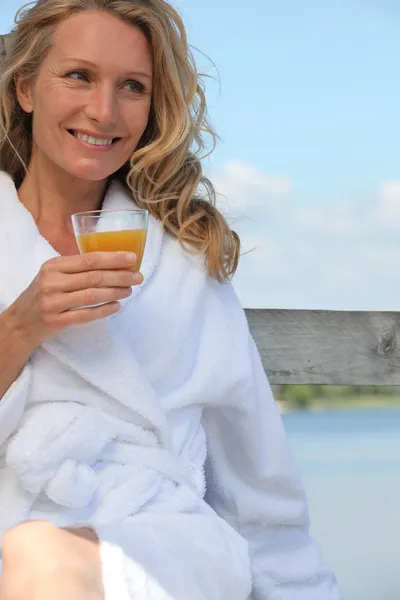 Woman with a glass of orange juice Stock Photo