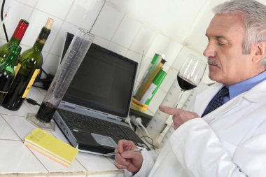 Oenologist analysing a wine clipart