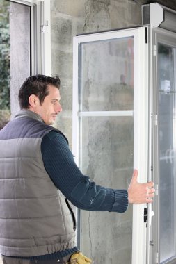 Worker installing French doors clipart