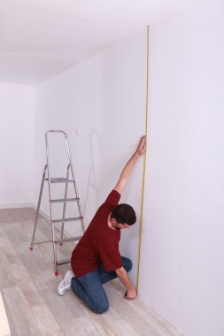 Man measuring wall clipart