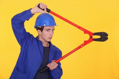 Young worker using a bolt cutter clipart