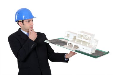 Architect considering a non-conventional model clipart