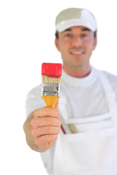 Decorator holding paintbrush — Stockfoto