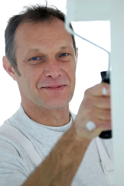 Friendly decorator with a roller — Stock Photo, Image