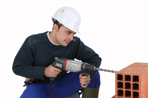 Man with a masonry drill — Stockfoto