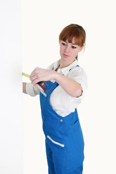 Female worker with a tape measure — Stockfoto