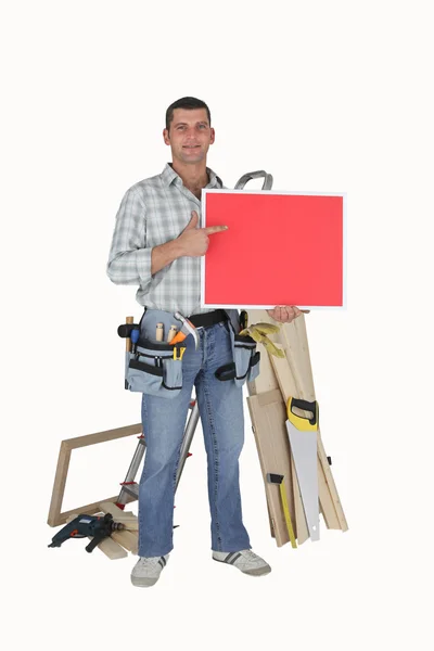 Mr. Fixit pointing to a red sign — Stockfoto