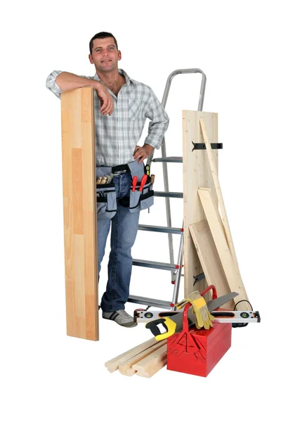 Carpenter with floorboards — Stockfoto