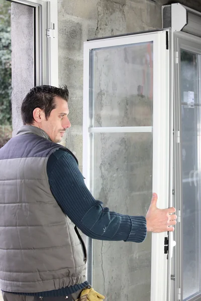 Worker installing French doors — Stock Photo, Image