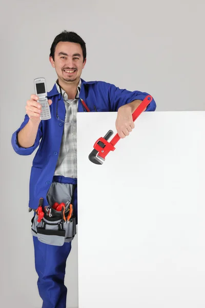Worker showing off his cellphone — Stock Photo, Image