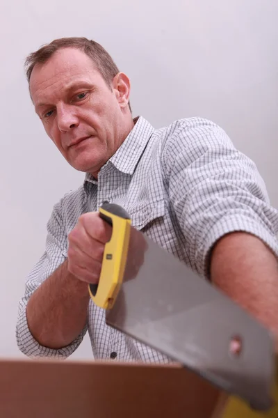 Man using hand-saw — Stock Photo, Image