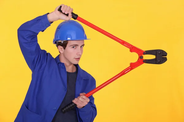 Young worker using a bolt cutter — Stock Photo, Image